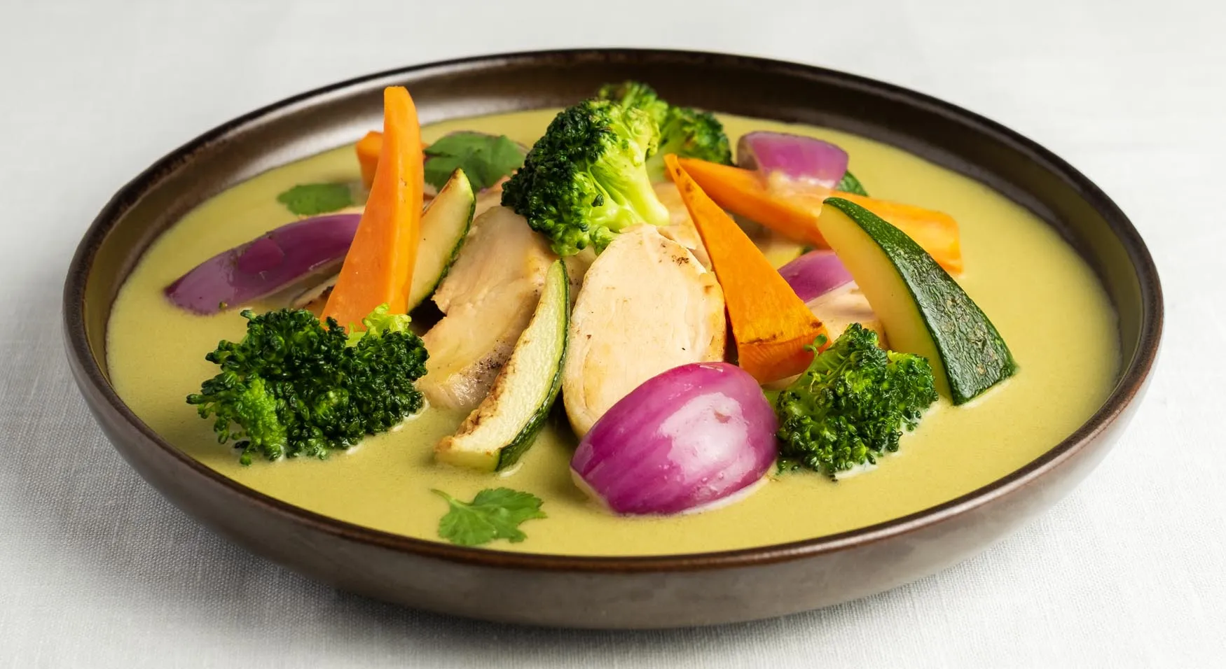 Pollo al curry verde tailandés respetando la receta tradicional, acompañado de verduras de temporada